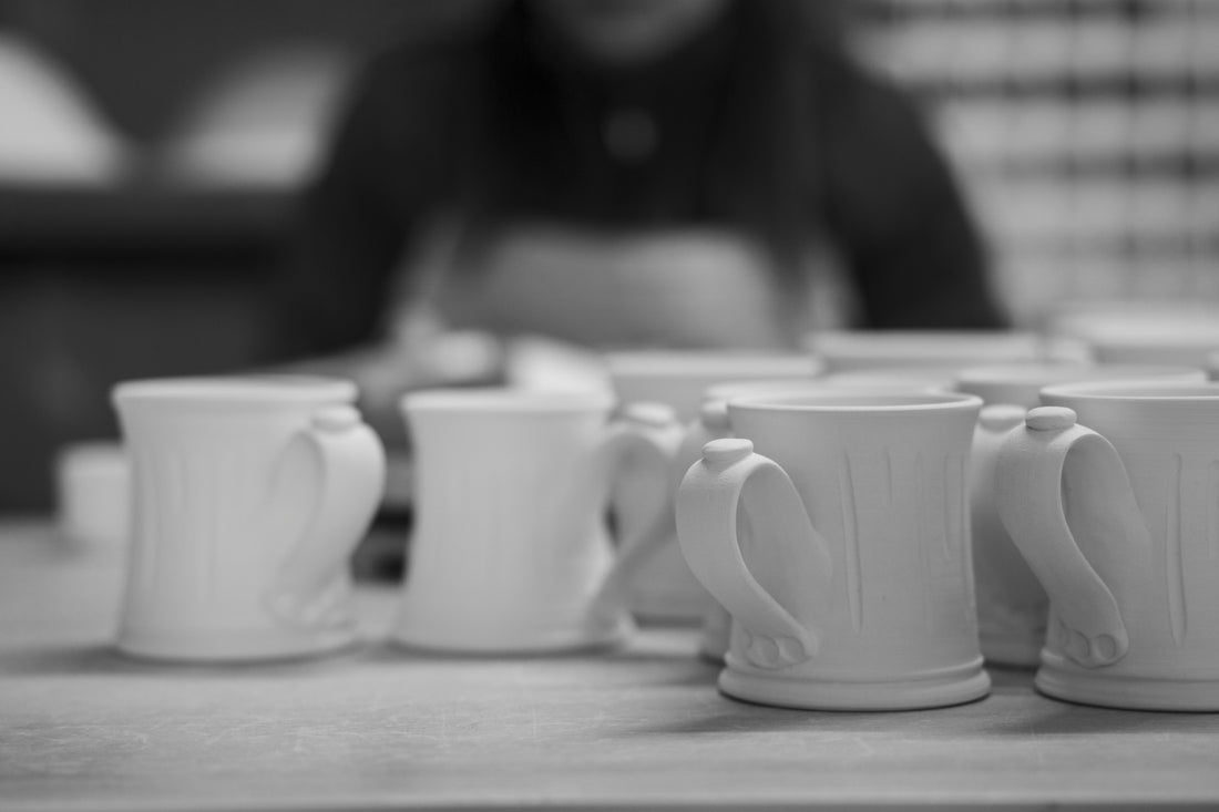 a row of coffee cups sitting on top of a table