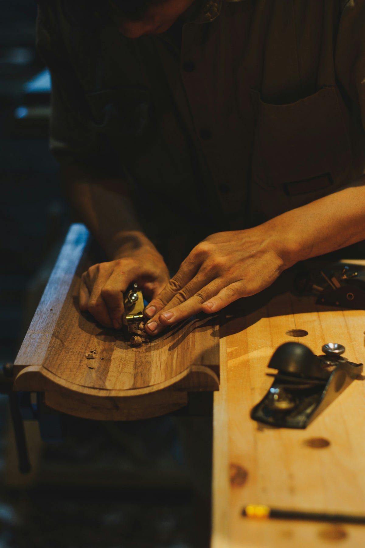 Woodworker shaping wood with a hand plane