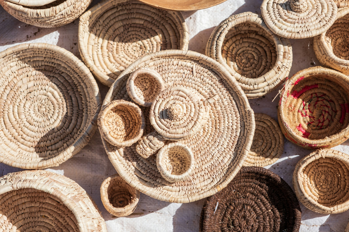 A collection of handmade woven baskets and trays