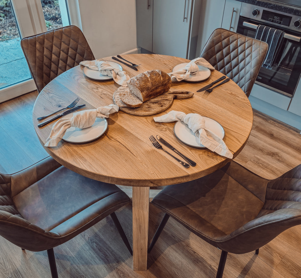 Solid Oak Round Dining Table With Wooden Legs and Leather Chairs