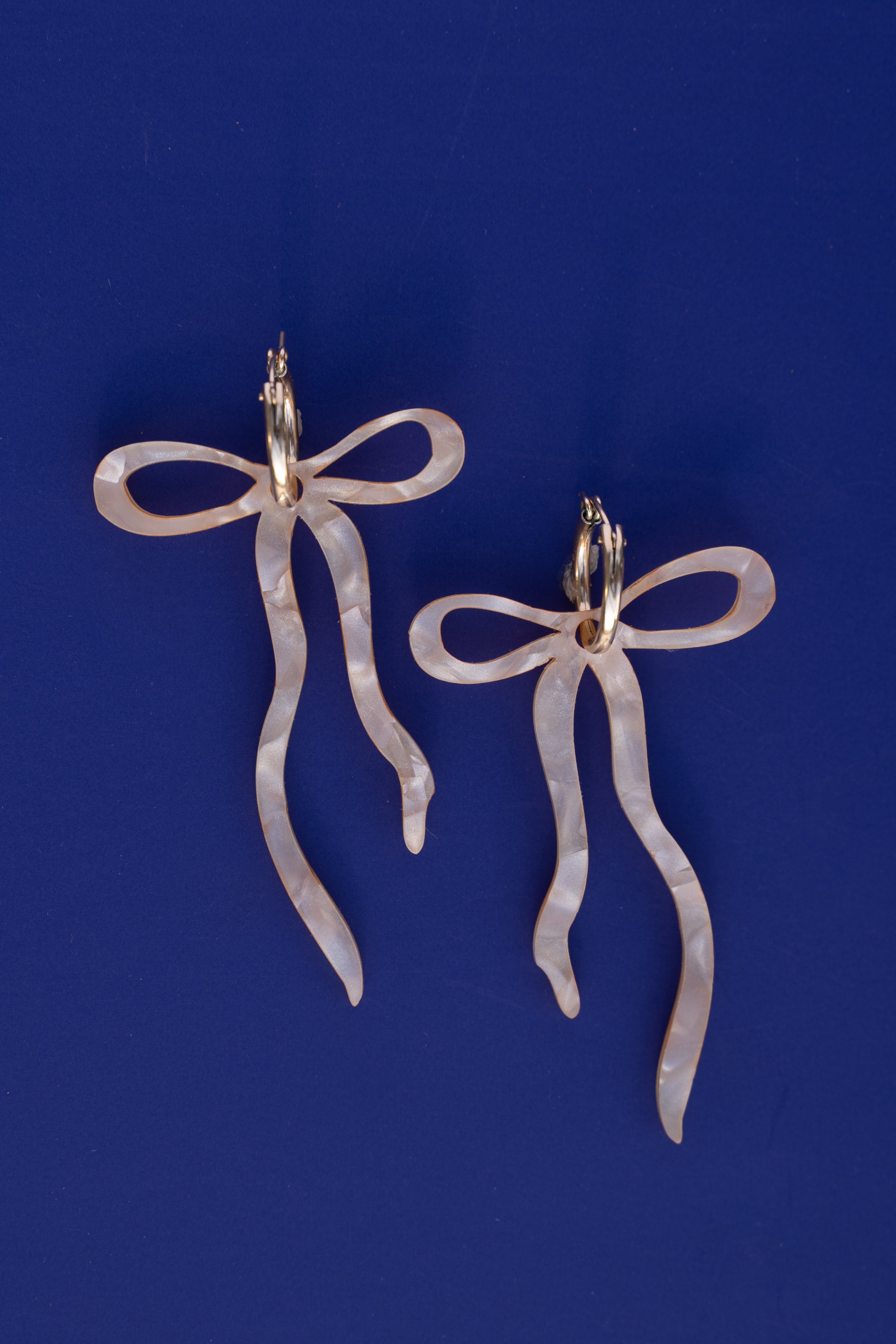 Pearlescent Beige Dangly Bow Hoop Earrings