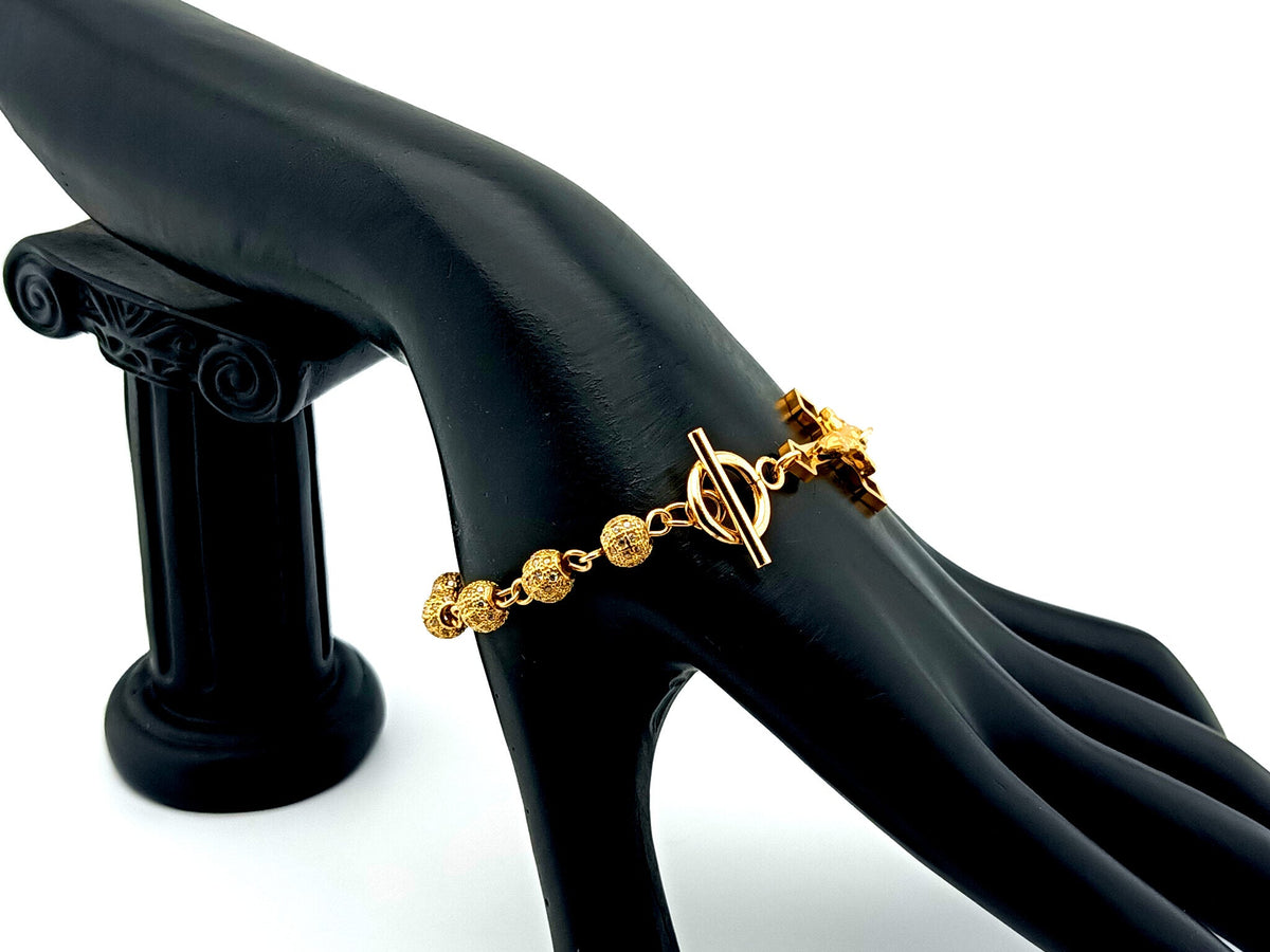 18K Gold cubic zirconia single decade rosary bracelet with gold plated Saint Benedict crucifix.