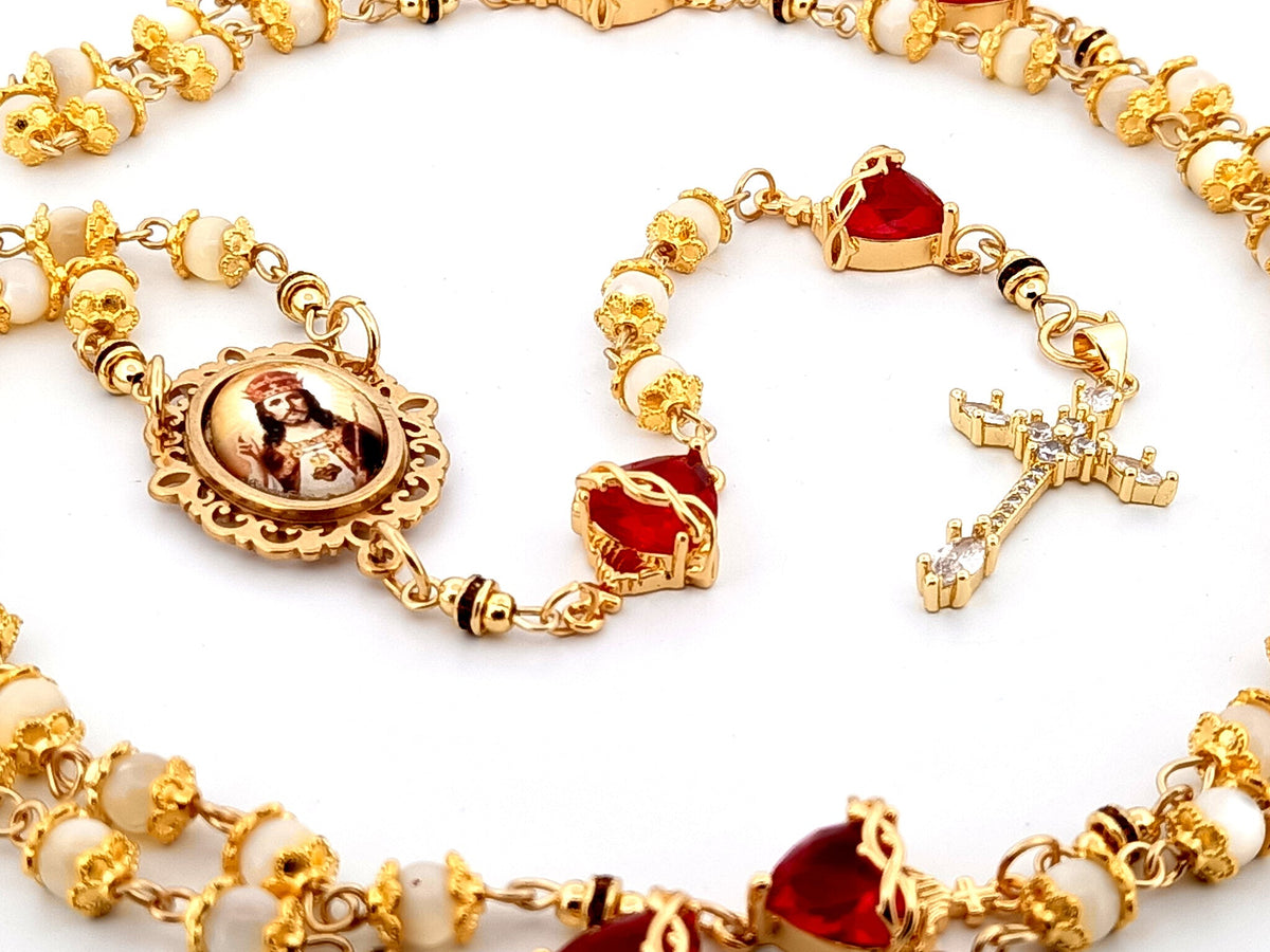 Christ the King mother of pearl and red crystal rosary beads with 18K gold plated cubic zirconia cross.