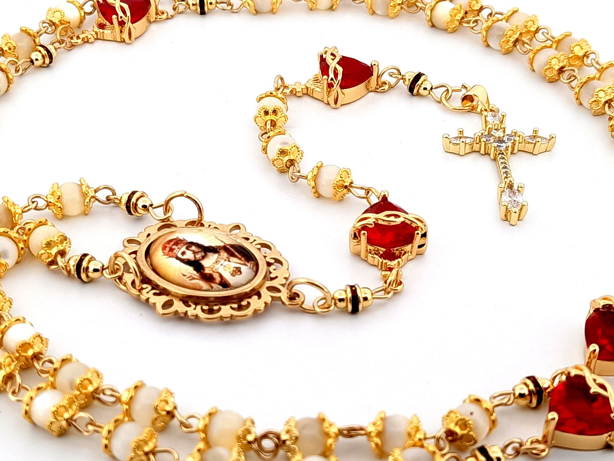 Christ the King mother of pearl and red crystal rosary beads with 18K gold plated cubic zirconia cross.
