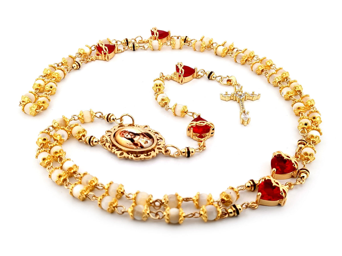 Christ the King mother of pearl and red crystal rosary beads with 18K gold plated cubic zirconia cross.
