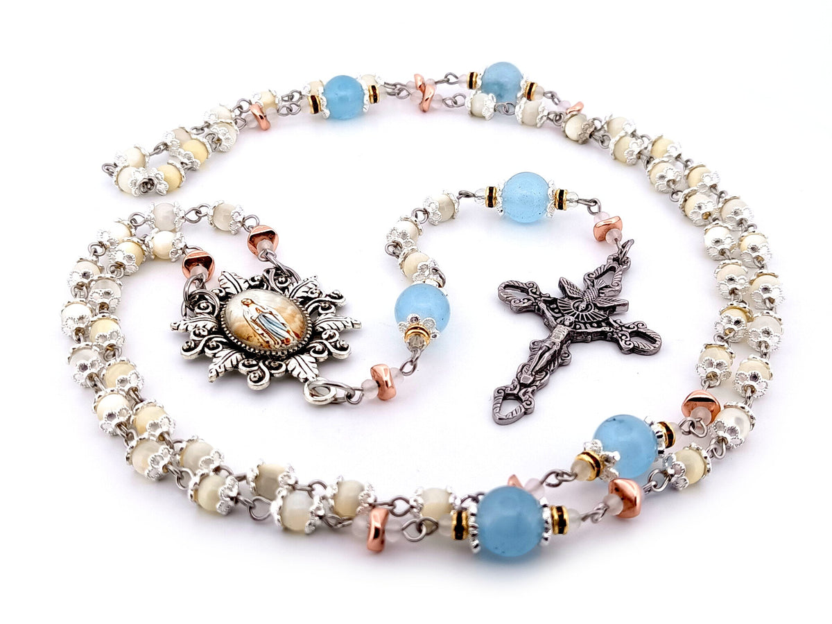 Immaculate Conception mother of pearl and blue glass rosary beads with Holy Spirit crucifix.