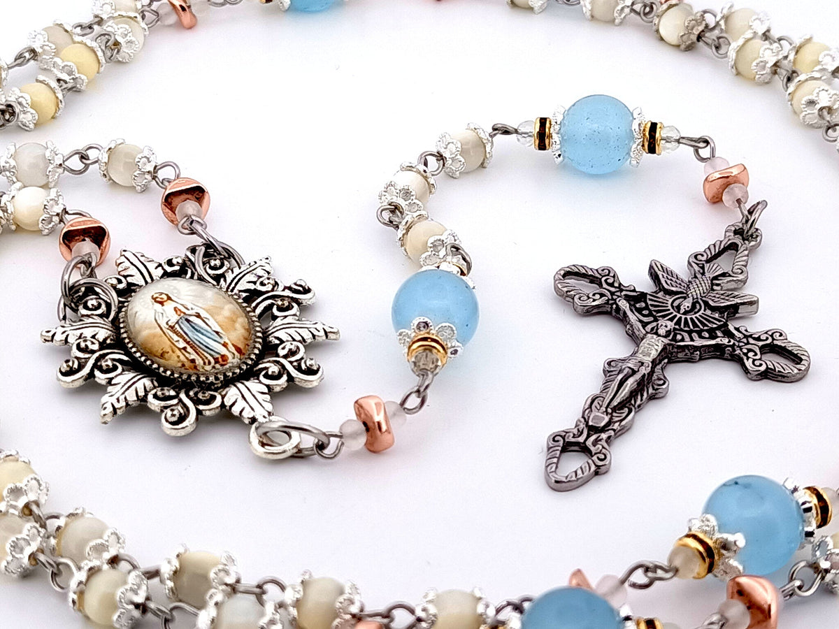 Immaculate Conception mother of pearl and blue glass rosary beads with Holy Spirit crucifix.