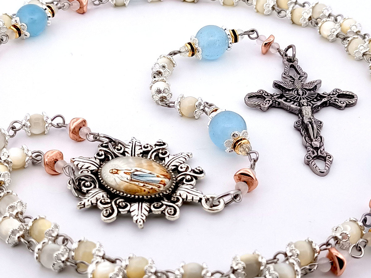 Immaculate Conception mother of pearl and blue glass rosary beads with Holy Spirit crucifix.