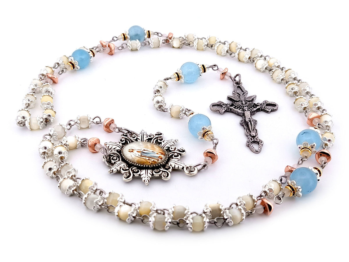 Immaculate Conception mother of pearl and blue glass rosary beads with Holy Spirit crucifix.