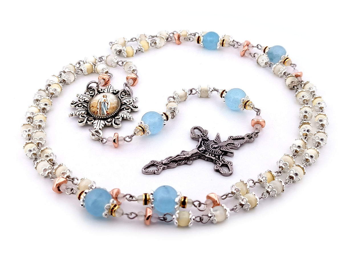 Immaculate Conception mother of pearl and blue glass rosary beads with Holy Spirit crucifix.