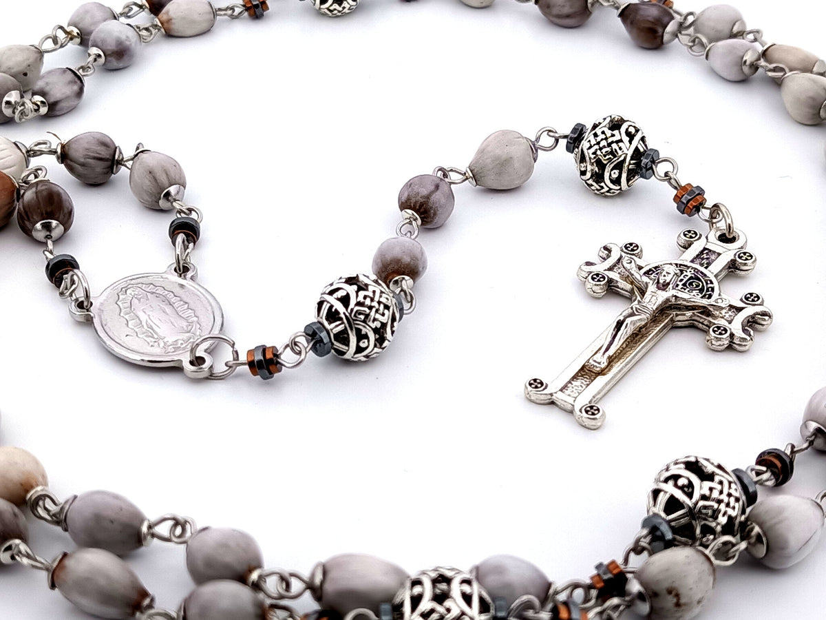 Our Lady of Guadalupe Jobs tears and silver rosary beads with Saint Benedict crucifix.