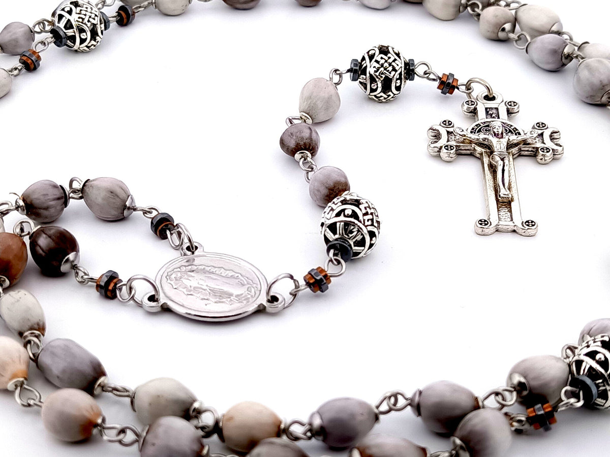 Our Lady of Guadalupe Jobs tears and silver rosary beads with Saint Benedict crucifix.
