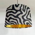 Black wiggle drum lampshade/ ceiling shade with a metallic brushed gold lining