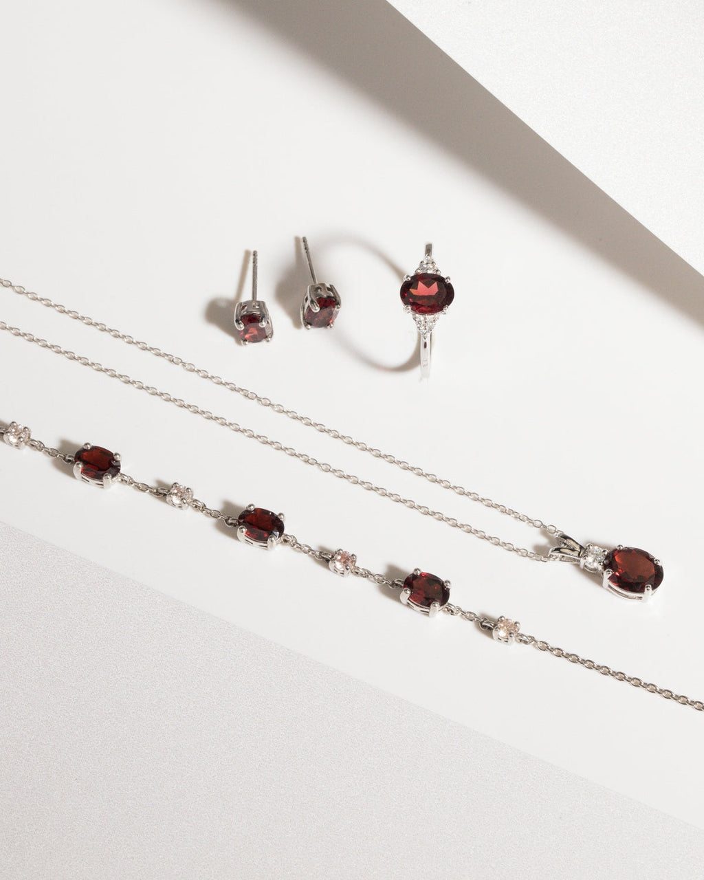 Garnet Oval Stud Earrings in Sterling Silver